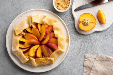 Appetite summer peach galeta on white table with copy space. summer open tart photo for cook book or food blog.