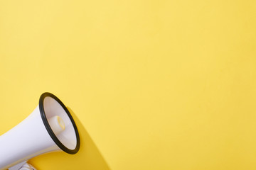 top view of loudspeaker on yellow background with copy space
