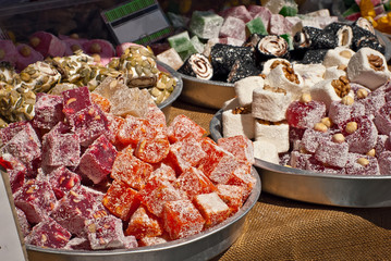 Turkish national sweets are sold at the fair. Multi-colored Asian desserts stacked on the table....