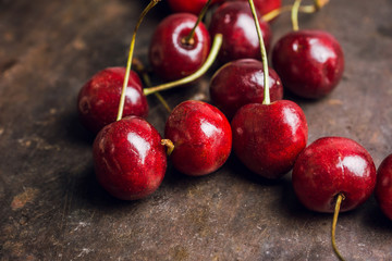 Ripe and juicy cherries on the dark rustic background. Selective focus. Shallow depth of field. 