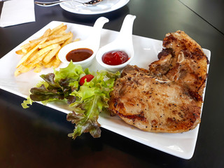 Pork steak with french fries ,vegetables and sauce