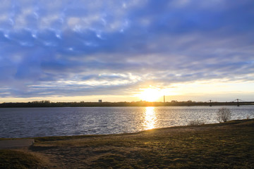 Sunset over river Daugava, Riga, Latvia. Urban landscape in october.