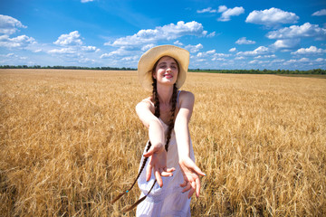 Come with me, young beautiful girl holds the hand of a man in a wheat field