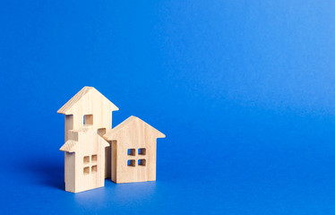 Three residential buildings figurine. The concept of buying and selling real estate, renting....
