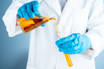 Young scientist with test tube making research in clinical laboratory.Professional science...