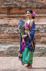 Beautiful young Muslim girl wearing hijab and dress known as Baju Kurung fashion, traditional...