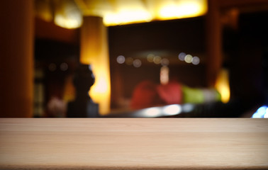 Empty dark wooden table in front of abstract blurred bokeh background of restaurant . can be used for display or montage your products.Mock up for space.