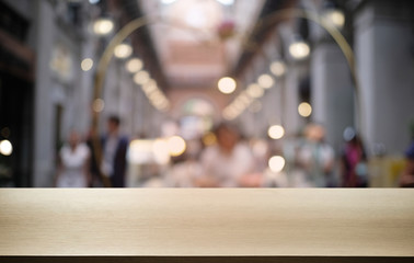 Empty dark wooden table in front of abstract blurred bokeh background of restaurant . can be used for display or montage your products.Mock up for space.