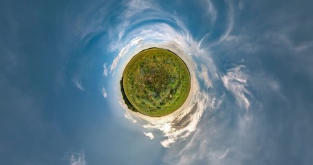 Little planet Transformation with curvature of space. Abstract torsion and spinning of full flyby panorama among fields in sunny evening with awesome clouds