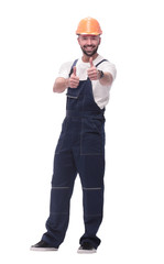 smiling man in overalls showing thumbs up . isolated on white