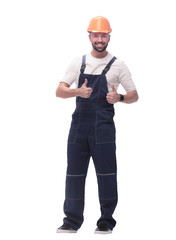 smiling man in overalls showing thumbs up . isolated on white