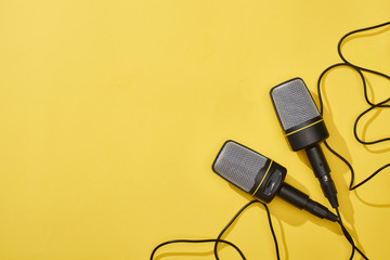 top view of microphones on bright and colorful background with copy space
