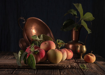 Classical still life with organic natural apples and vintage cooper decoration on old rustic wooden background. © twomeerkats