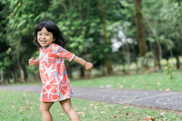 asian cute girl with smile enjoy playing alone in the garden