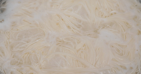 Cooking with somen in skillet in the kitchen