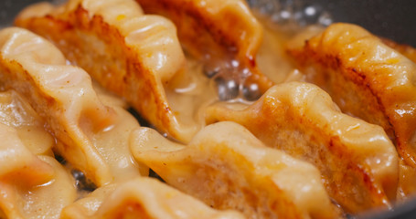 Fry meat dumpling on pan in kitchen