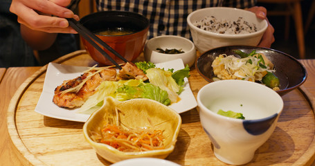 Set of the Japanese meal with bowl of rice and grilled fish