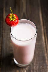 Strawberry milkshake with on the rustic background. Selective focus. 