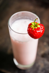 Strawberry milkshake with on the rustic background. Selective focus. 