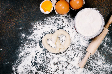 raw pretzel on aflour ready to be baked and ingredients