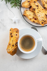 Christmas homemade cookies biscotti with dry berries and cup of coffee.
