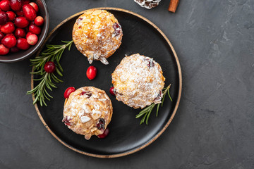 Muffins, cakes with cranberry, rosemary and almond nuts. Christmas decoration. Copy space.