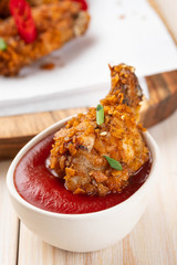 Chicken nuggets with sauce and pepper on a white board. Copy space.
