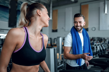 Fototapeta na wymiar attractive sports couple talking in the gym