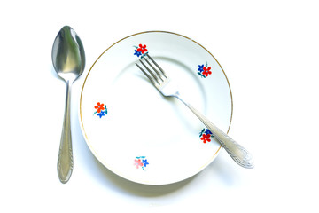 served table for meals. Fork, spoon and plate - simple breakfast, lunch or dinner.