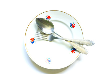 fork and spoon on an empty clean plate