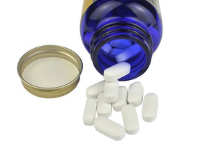 Open bottle of white pills – isolated on white background