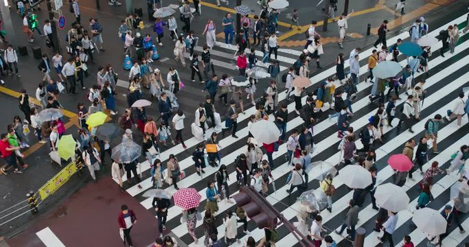 People cross the road in Ikebukuro district in city