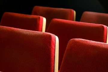 Obraz premium Empty red velvet seats for spectators in the theater or cinema. Red theater seats