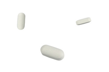 Three white pills – isolated on white background