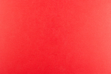 Red cardboard with relief horizontal lines suitable as a background