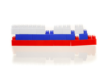 Flag of the Russian Federation from a multi-colored children's plastic building kit on a white background
