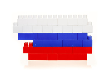 Flag of the Russian Federation from a multi-colored children's plastic building kit on a white background