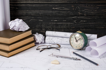 Rolls with drawings, design books and several drawing tools