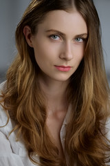 Naklejka premium Low key portrait of beautiful girl with long curly hair
