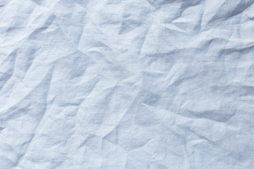 light blue background with crumpled linen cloth