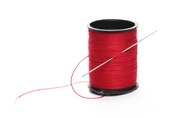 Spool of sewing threads with needle isolated on white background