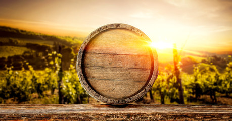 Wooden old retro barrel and autumn landscape with sunset time. 