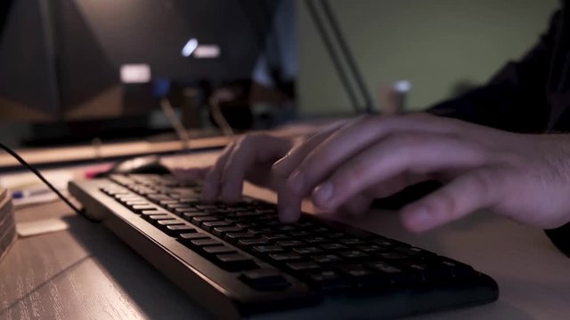 Close up of businessman hands typing on computer keyboard lying on a wooden table in the office, management concept. Stock footage. Male fingers typing message on the keyboard.