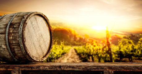Wooden old retro barrel and autumn landscape with sunset time.  © magdal3na