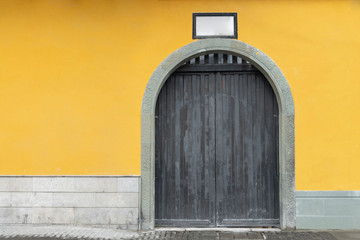 yellow wall and door stone at the jade Buddha temple, Shanghai, china