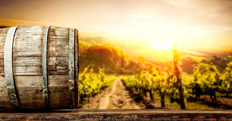 Wooden old retro barrel and autumn landscape with sunset time. 