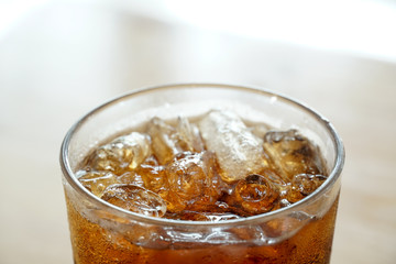 Close up top view of cola in a glass.