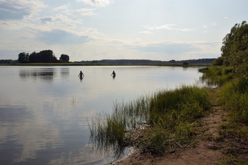 People swimming in the lake in the summer on the nature