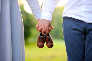 Happy and young pregnant couple walking outdoor