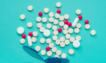 Different pharmaceutical pills and capsules from a jar.
